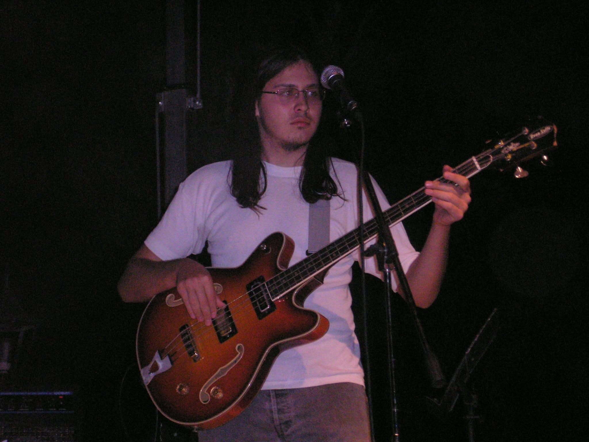 Thanos playing bass and singing on stage in 2005