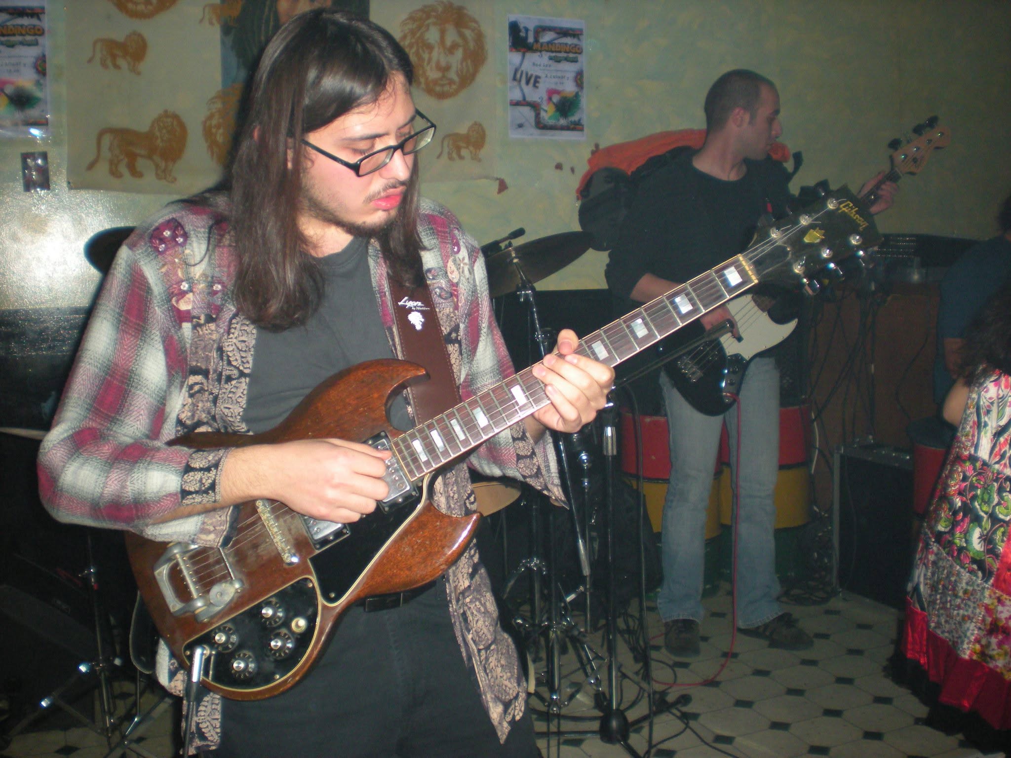Thanos performing live on electric guitar in 2010